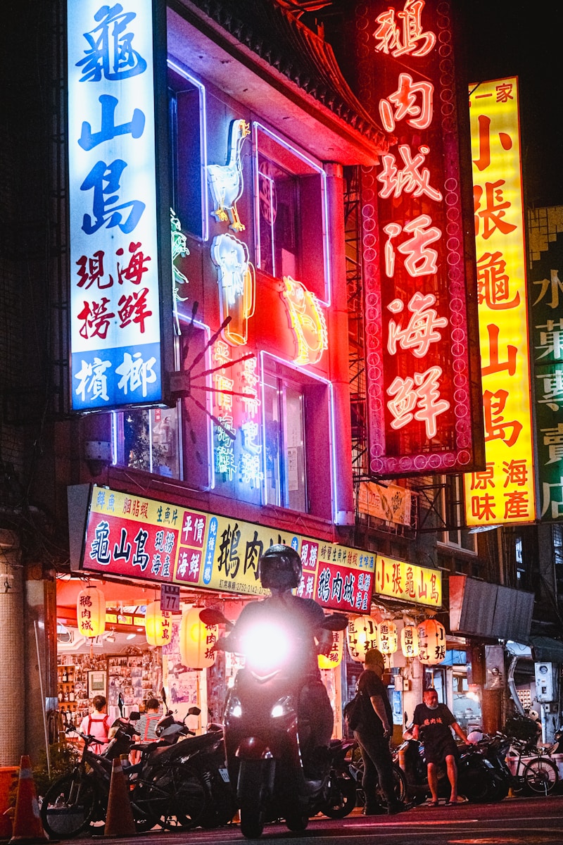 a man on a motorcycle parked in front of a building